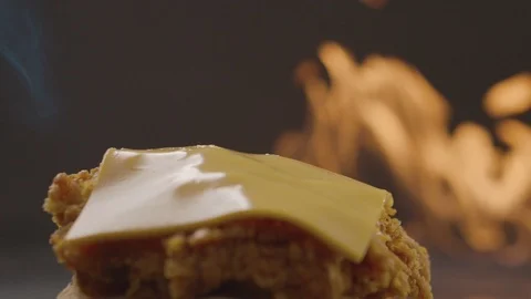 Cook uses blow torch to melt cheese on meat cutlet. Slow motion video Stock Footage 114428788