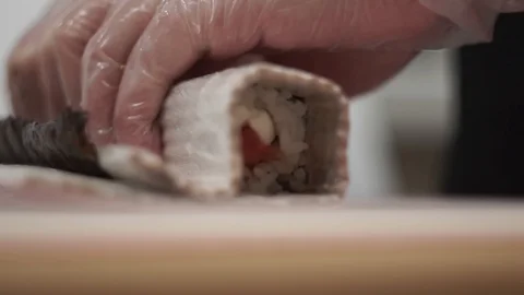 The cook using the mat twists the rolls Stock Footage 106670220