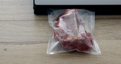 The cook vacuum packing beef steaks in a bag for sous-vide 動画素材 125434671