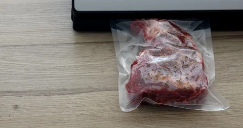 The cook vacuum packing beef steaks in a bag for sous-vide 動画素材 125434846