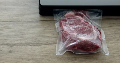 The cook vacuum packing beef steaks in a bag for sous-vide 動画素材 125434862