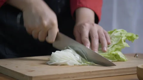 Cook was using knife to cut vegetable in the kitchen. Stock Footage 139573857