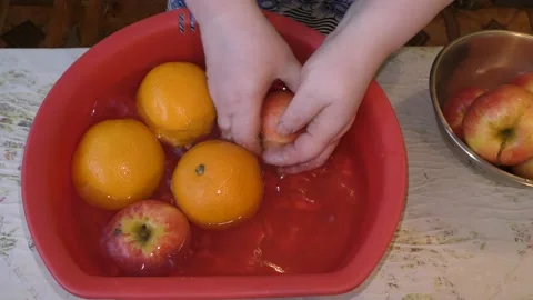 The cook washes the apples and oranges in the water. healthy food concept Stock Footage 140406565