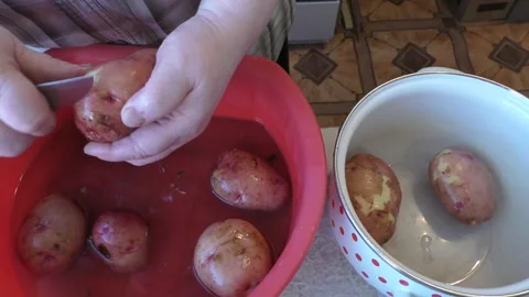 The cook washes potatoes in water Stock Footage 164283566