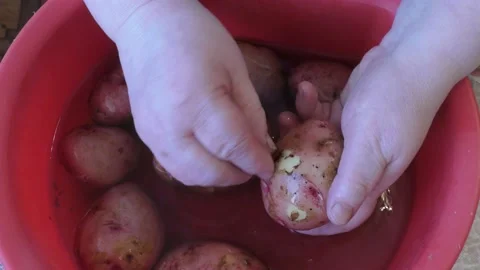 The cook washes potatoes in water Stock Footage 168049895