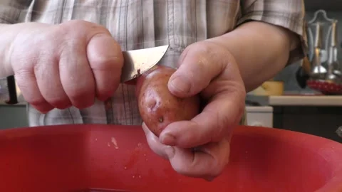 The cook washes potatoes in water Video stock 168049970
