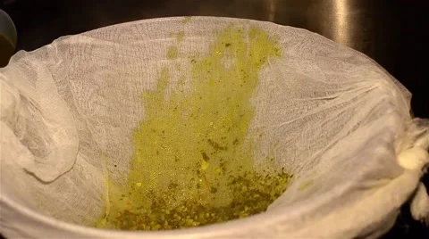 Cook which strain the soup through a cheesecloth into a large pot on the stove Vídeos de archivo 63391866