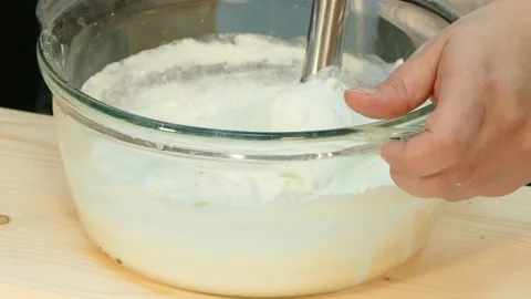 The cook whips the cheese mass with a blender. Stock Footage 88501898