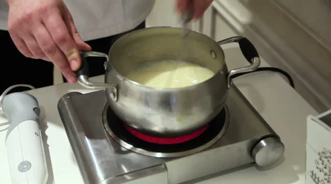 Cook whips the cream in a saucepan 스톡 동영상 59356334
