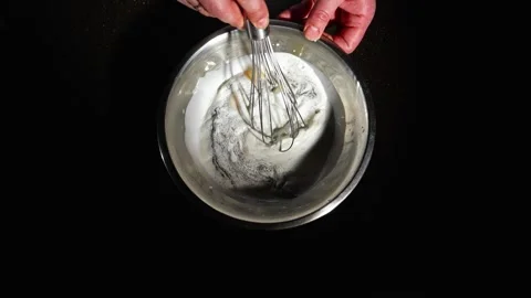 The cook whips the egg yolks while making the dough. Stock-Footage 264404108