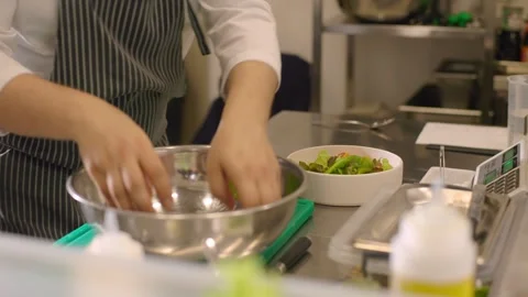 The cook is working. The process of preparing a bowl of fresh vegetables. Stock Footage 277131886