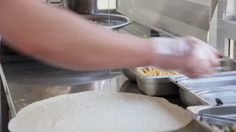 Cook wraps meat and vegetables in a pita bread for cooking shawarma. Stock Footage 50180019