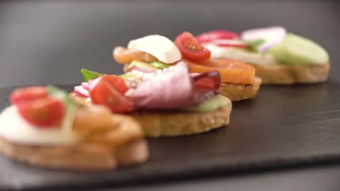 Cooked appetizers on the table. A classic Italian bruschetta with tomato cheese Stock Footage 196321539