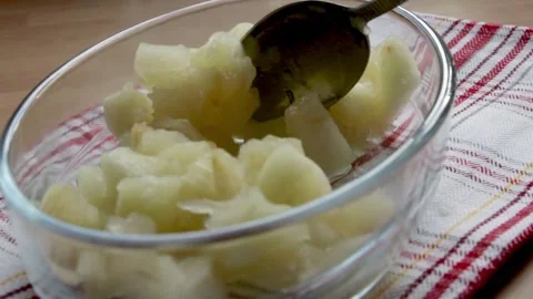 Cooked Apple being spooned into a bowl Stock Footage 142285891