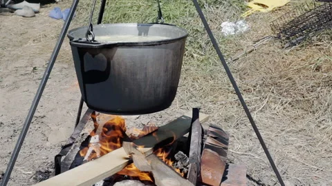 Cooked on the background of nature on a fire in a cauldron of boiling water Stock Footage 157456268