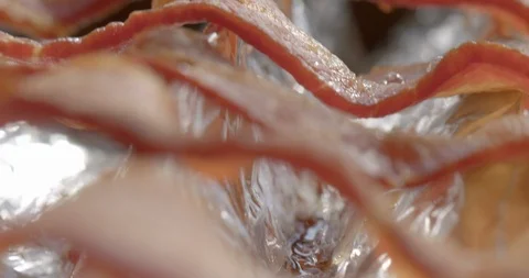 Cooked bacon, seen edge on, hand-held slow motion macro 4K Stock Footage 126944823