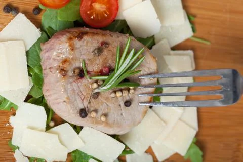 Cooked beef on arugula and parmesan Stock Photos