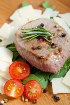 Cooked beef on arugula and parmesan Stock Photos