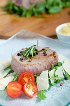 Cooked beef on arugula and parmesan Stock Photos