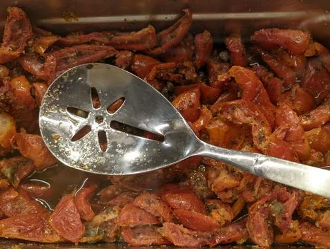 Cooked beef chunks with a metal slotted spoon Stock-Fotos