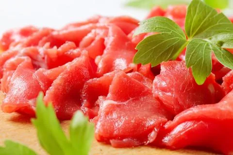 Cooked beef cubes with parsley garnish Stock Photos