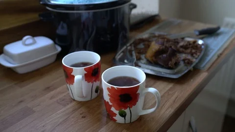 Cooked beef leftovers on tray with two steaming mugs of black coffee, 4k 스톡 동영상 86981025