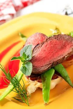 Cooked beef steak with fresh herbs and veggies Stock Photos