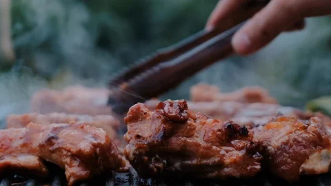 Cooked beef steak or pork ribs, toasting meat on a metal electric grill Stock Footage 119684946