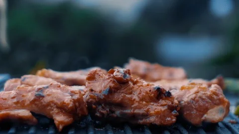 Cooked beef steak or pork ribs, toasting meat on a metal electric grill Stock Footage 119685035