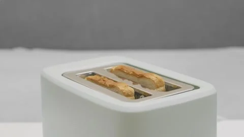 Cooked bread toasts jump out of the toaster Stock Footage 276756004