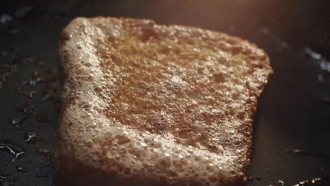Cooked brioche bread crispy toast steaming in a hot frying pan 스톡 동영상 150670750