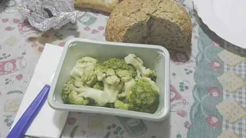 Cooked Broccoli in Green Container with Bread on Table Stock Footage 320396475