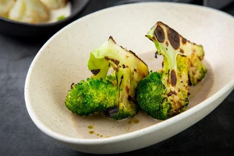 Cooked broccoli in mushroom sauce and lime Stock Photos