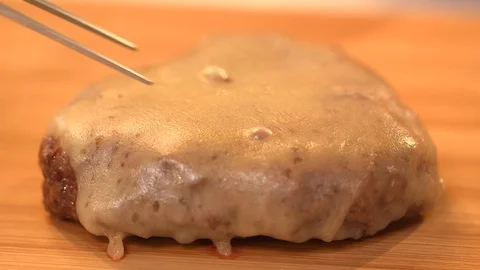 Cooked cheeseburger. Cut open rare burger. cu Stock Footage 102139840