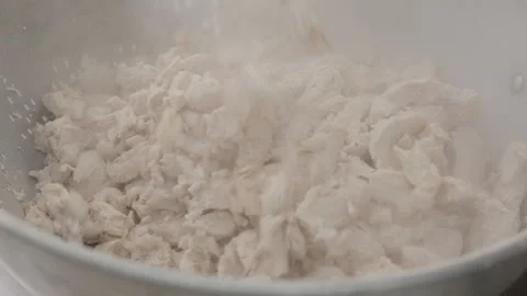 COOKED CHICKEN BEING DUMPED INTO A COIN FULL OF CHICKEN Stock Footage 289512734