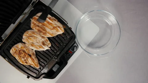 Cooked chicken breasts put on plate Video stock 165665816