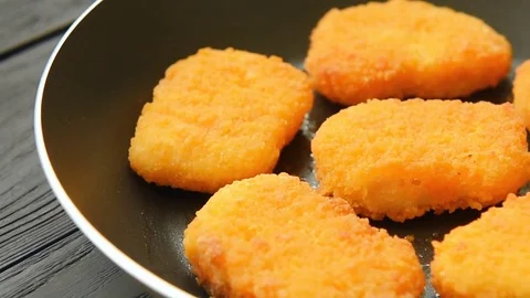 Cooked chicken nuggets in frying-pan Stock Footage 70086949