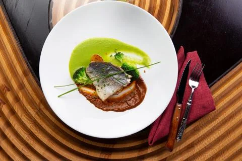 Cooked cod fillet in a plate. Stock Photos