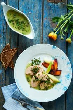 Cooked cod roe with a caper sauce and root vegetables Stock Photos