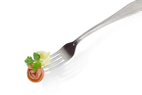 Cooked colored pasta on the fork on a light background Stock Photos