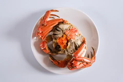 Cooked crab on white plate top view Stock Photos