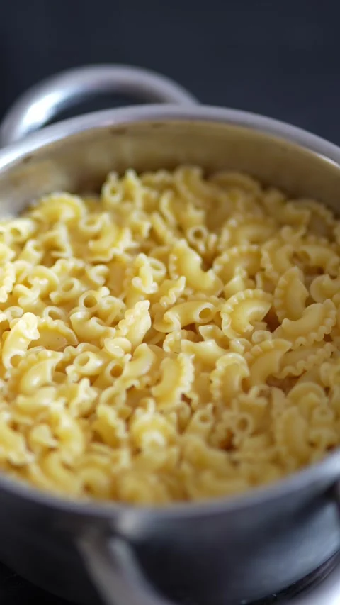 Cooked creste di gallo pasta served in a metal pot Stock Footage 332638338