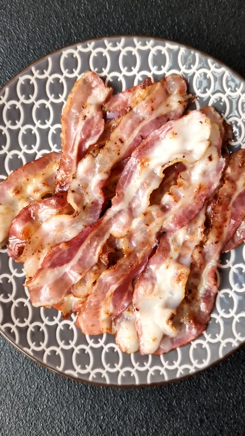 Cooked crispy bacon, slices of roast pork for an English breakfast. Fried bacon Video stock 309936431