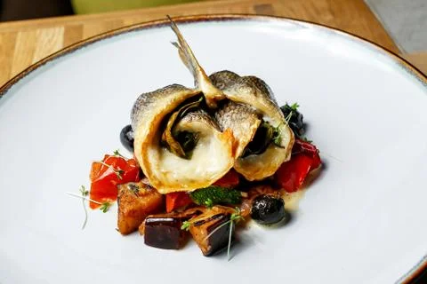 Cooked fish in a roll with vegetables Stock Photos