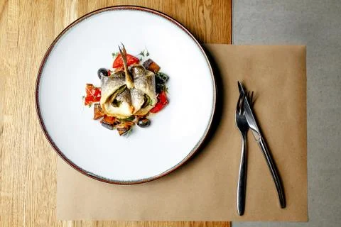 Cooked fish in a roll with vegetables Stock Photos