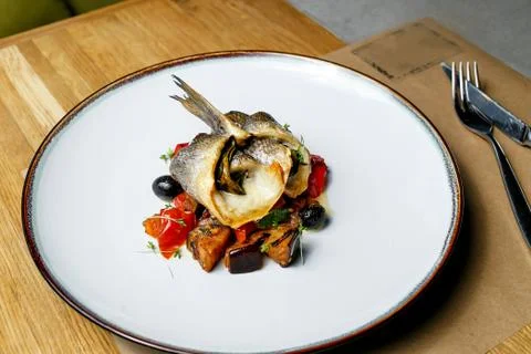 Cooked fish in a roll with vegetables Stock Photos