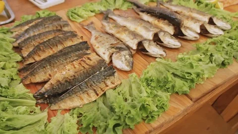 Cooked fish with salad on the table at the street food festival. Video stock 83080402