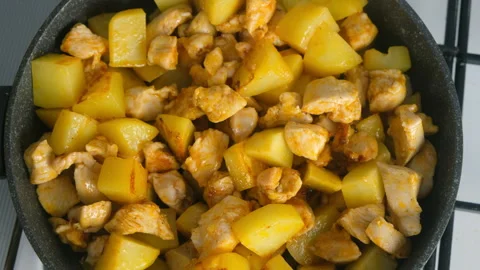 Cooked fried chicken and potatoes cooking in frying pan on kitchen. Stock Footage 312469288