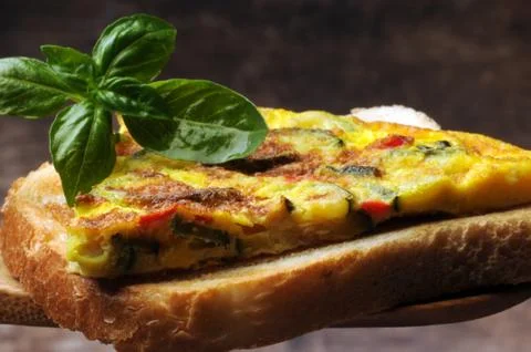 Cooked frittata with zucchini on slice of bread Stock Photos