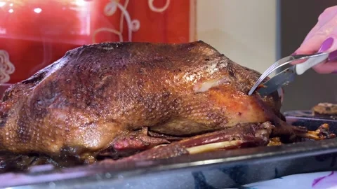 Cooked goose is cut with knife Stock-Footage 221637216